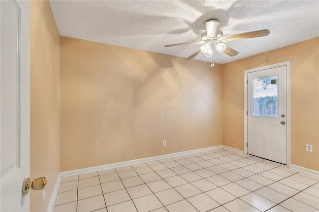 tiled foyer with ceiling fan and a textured ceiling