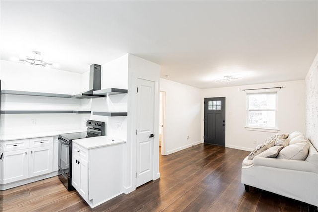 529 Central Ave, Jefferson, LA 70121 - kitchen with black range with electric stovetop, wall chimney exhaust hood, open shelves, open floor plan, and light countertops