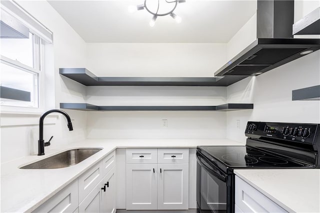 529 Central Ave, Jefferson, LA 70121 - kitchen with black electric range, open shelves, a sink, wall chimney range hood, and white cabinetry