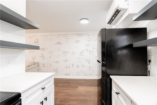 529 Central Ave, Jefferson, LA 70121 - kitchen featuring dark wood-style flooring, an AC wall unit, baseboards, white cabinetry, and light countertops