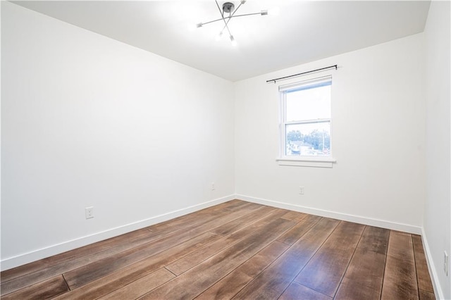 529 Central Ave, Jefferson, LA 70121 - unfurnished room with wood-type flooring, baseboards, and a chandelier