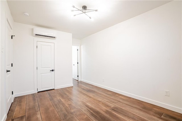 529 Central Ave, Jefferson, LA 70121 - unfurnished bedroom featuring a wall mounted air conditioner, wood finished floors, and baseboards