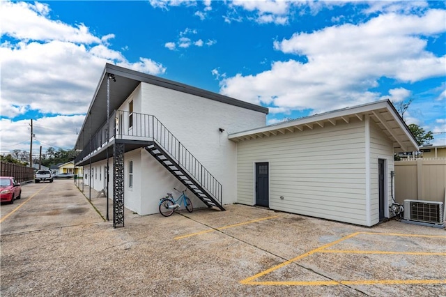 529 Central Ave, Jefferson, LA 70121 - rear view of property featuring cooling unit, stairway, and uncovered parking