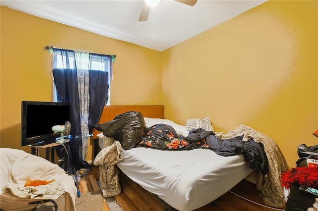 bedroom featuring wood-type flooring and ceiling fan