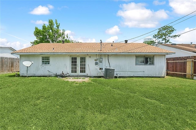 back of house with french doors, a lawn, and central air condition unit