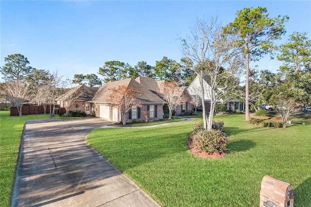 view of front of property with a garage and a front lawn