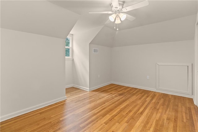 bonus room featuring vaulted ceiling, light hardwood / wood-style floors, and ceiling fan