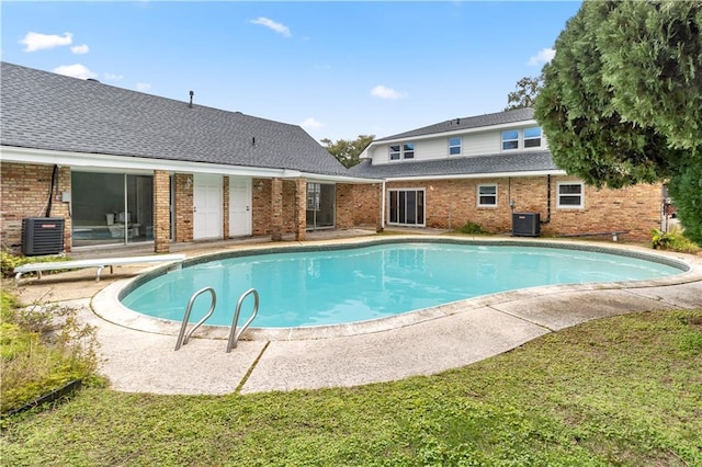 view of pool featuring a diving board and central AC