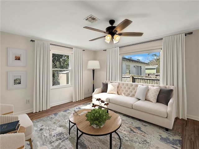 living room featuring ceiling fan and hardwood / wood-style flooring