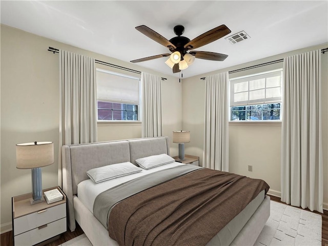 bedroom with ceiling fan and wood-type flooring