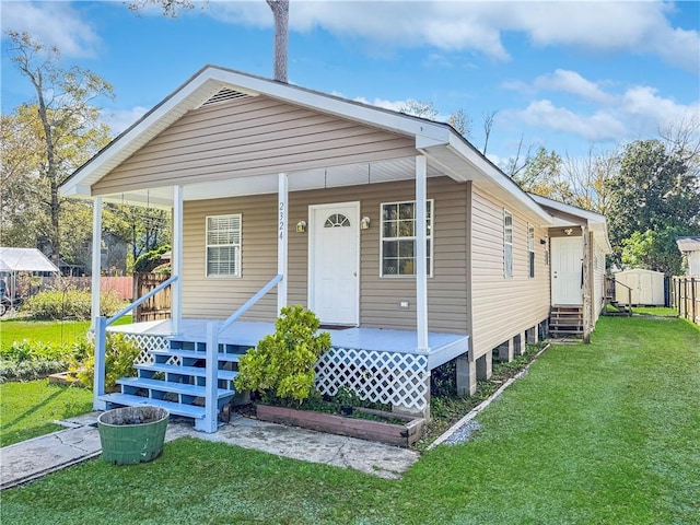 bungalow-style house featuring a front lawn and covered porch