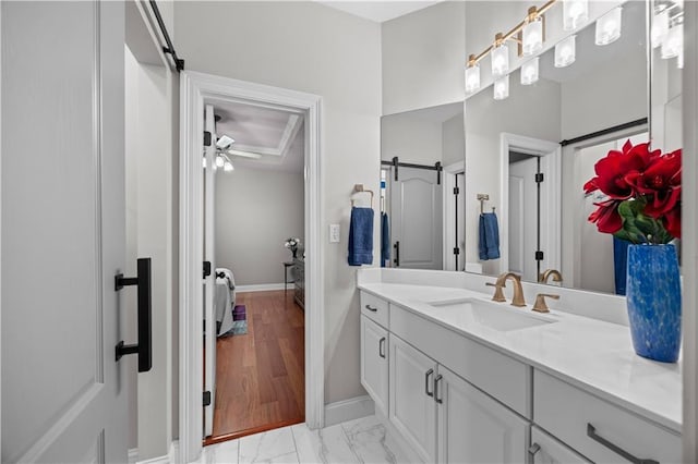 bathroom with ceiling fan and vanity