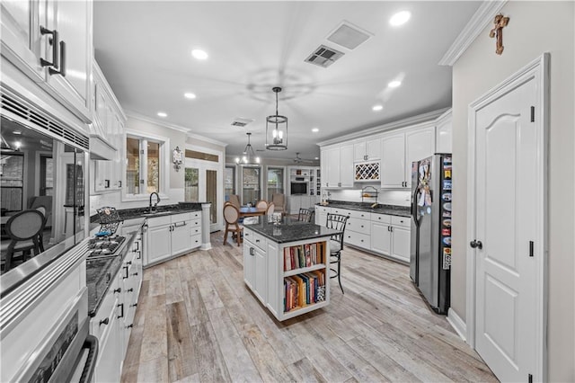 kitchen featuring white cabinets, a kitchen island, and appliances with stainless steel finishes