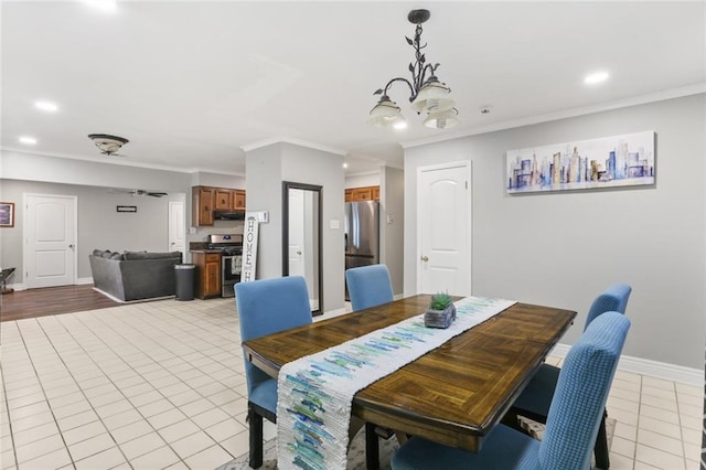 dining area featuring light tile patterned floors and crown molding