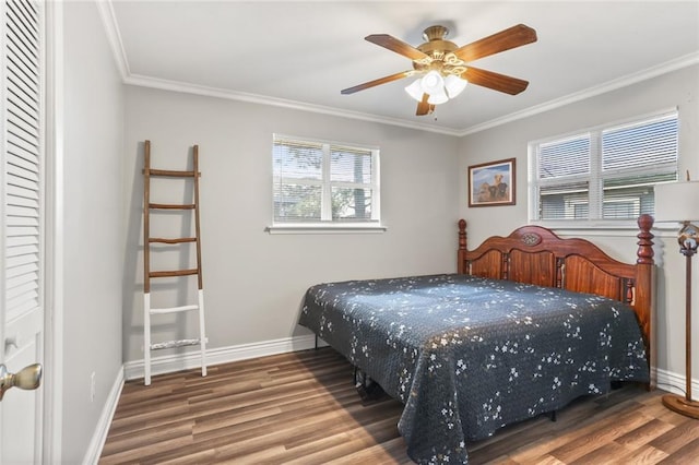 bedroom featuring hardwood / wood-style floors, ceiling fan, and crown molding