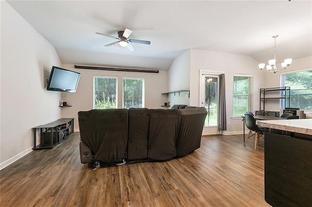 living room with dark hardwood / wood-style flooring, ceiling fan with notable chandelier, and lofted ceiling