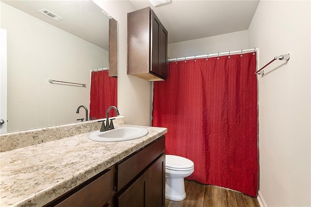 bathroom featuring vanity, toilet, and wood-type flooring