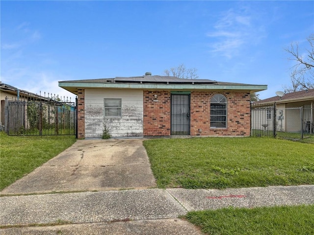 view of front facade featuring solar panels and a front yard