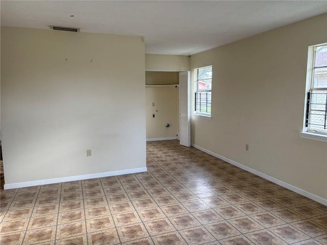 unfurnished room featuring plenty of natural light