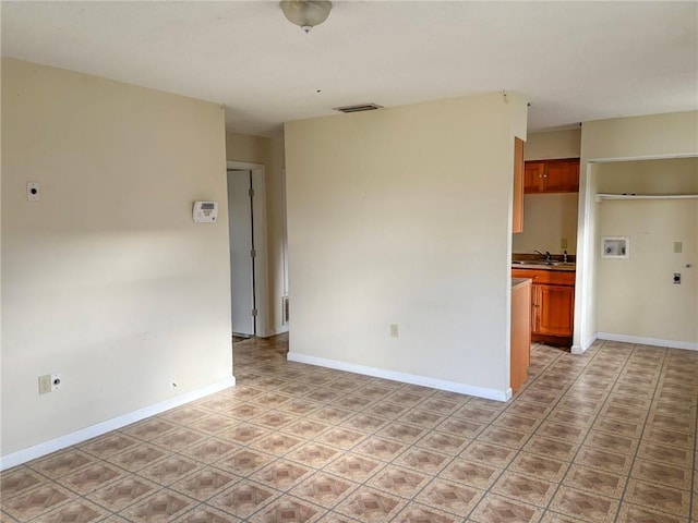 unfurnished room featuring sink