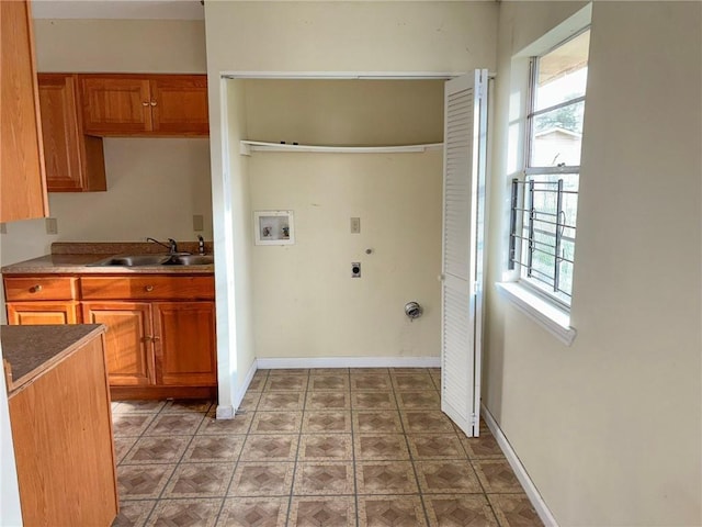 laundry room featuring hookup for an electric dryer, washer hookup, and sink