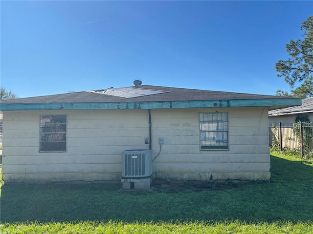 view of property exterior featuring cooling unit and a yard