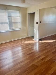 unfurnished room with dark hardwood / wood-style floors