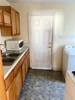 laundry area featuring cabinets, sink, and washer / clothes dryer