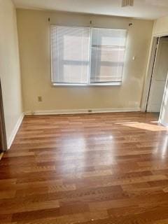 unfurnished bedroom featuring dark hardwood / wood-style flooring