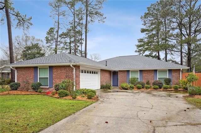 ranch-style home featuring a garage and a front lawn