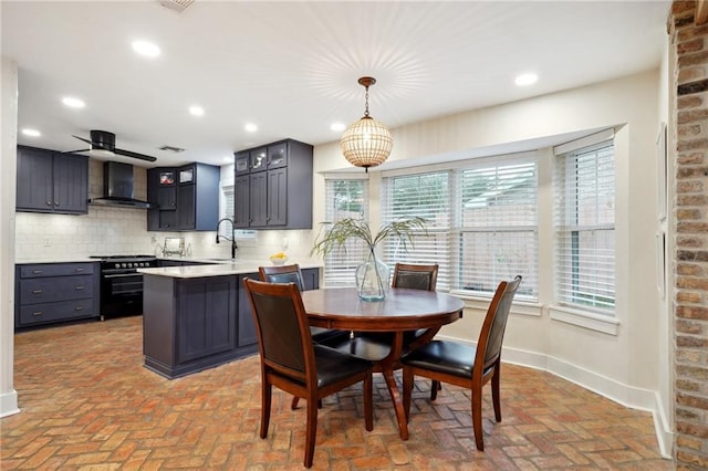 dining area with ceiling fan and sink