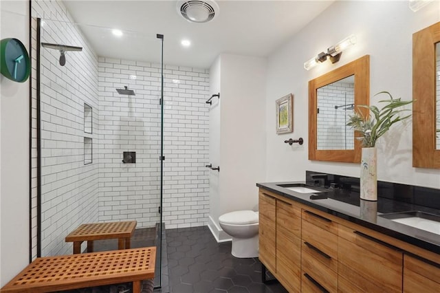 bathroom with tile patterned flooring, vanity, toilet, and an enclosed shower