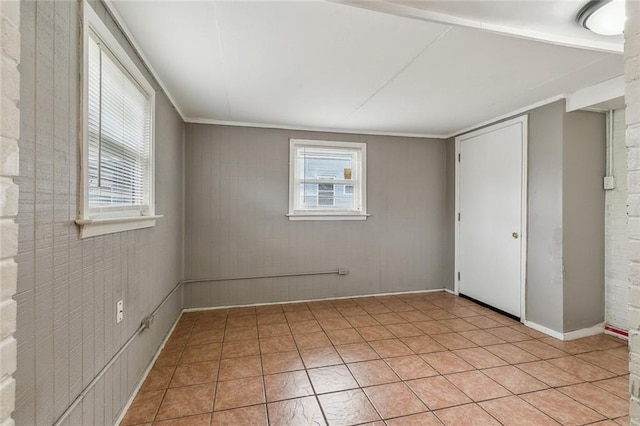 unfurnished bedroom with light tile patterned floors and crown molding