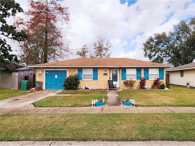 single story home featuring a garage and a front yard