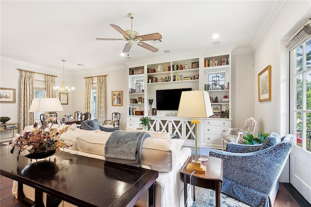 living room featuring dark hardwood / wood-style flooring, crown molding, and ceiling fan with notable chandelier