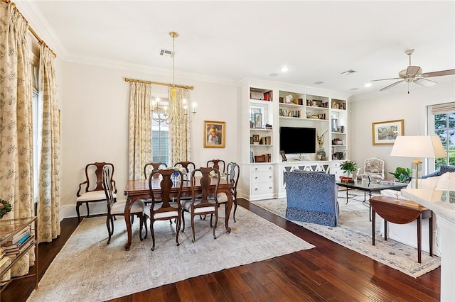 dining room featuring hardwood / wood-style flooring, crown molding, and ceiling fan with notable chandelier