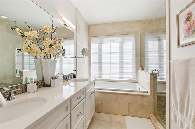 bathroom with tile patterned floors, independent shower and bath, and vanity