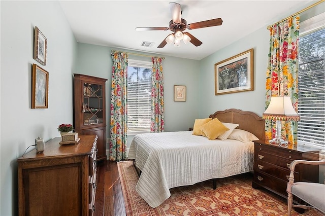 bedroom with ceiling fan and dark hardwood / wood-style floors