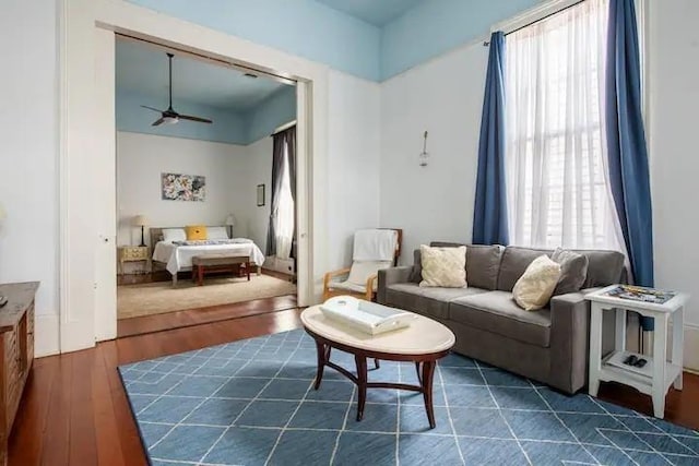 living room with ceiling fan, dark hardwood / wood-style flooring, and plenty of natural light