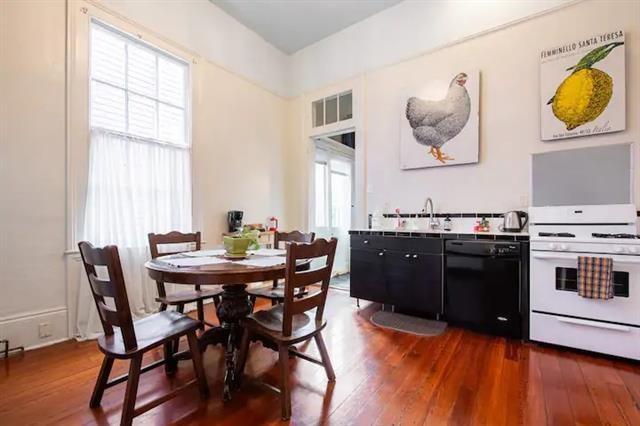 dining space with dark hardwood / wood-style floors, a wealth of natural light, and sink