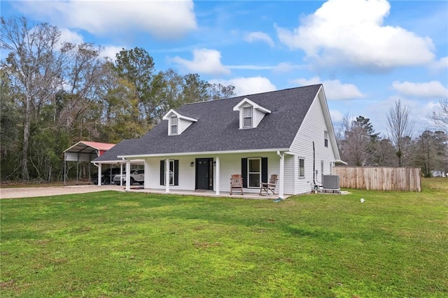 cape cod home featuring a porch, central AC unit, a front yard, and a carport