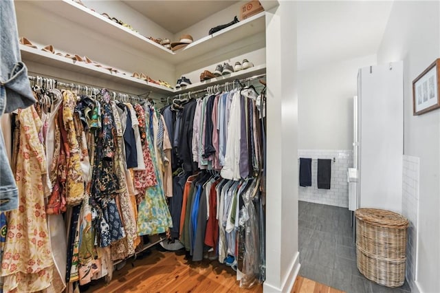 walk in closet with wood-type flooring