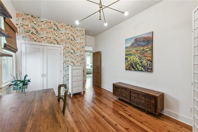 interior space with hardwood / wood-style floors and an inviting chandelier