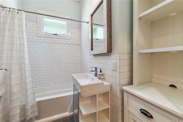 bathroom featuring shower / bathtub combination with curtain and tile walls