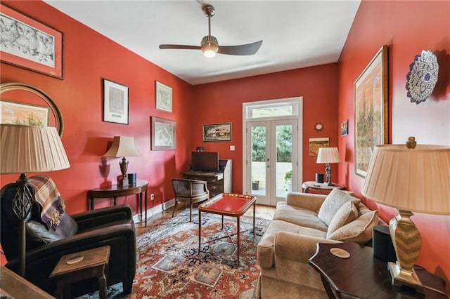 living room with ceiling fan and french doors