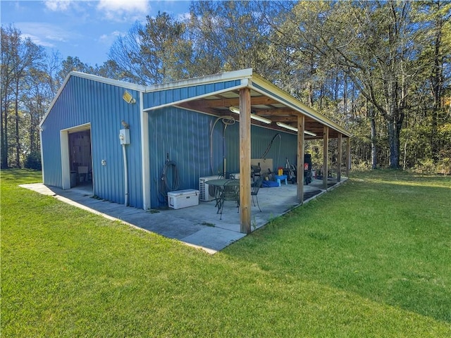 view of outdoor structure featuring a garage and a lawn