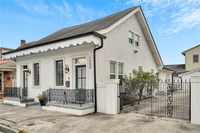 1508 N Roman St, New Orleans, LA 70116 - view of front of property with brick siding, fence, and a gate