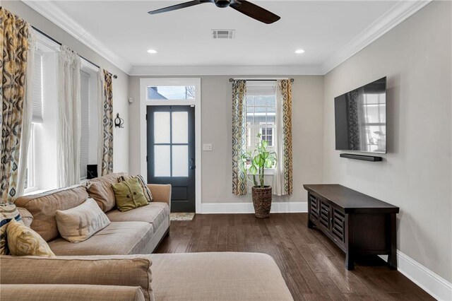 living room with crown molding, dark hardwood / wood-style floors, and ceiling fan