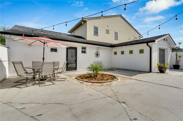 1508 N Roman St, New Orleans, LA 70116 - rear view of property with a shingled roof, a patio area, and stucco siding