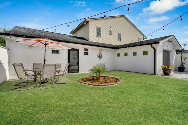 1508 N Roman St, New Orleans, LA 70116 - back of house with roof with shingles, stucco siding, and a lawn